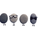 4 Mr. fuzz material potatoe heads. One with glasses on whilst the last has a black bow tie on.