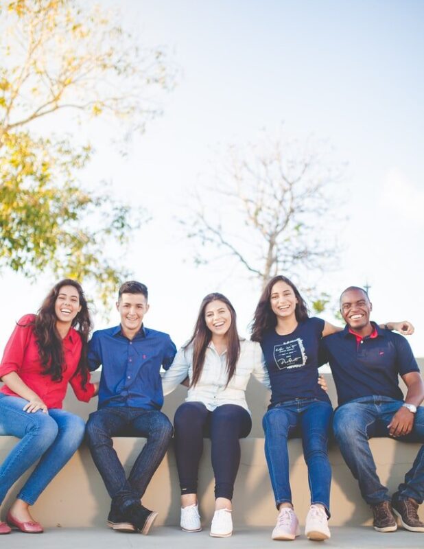 A group of young people sitting on a wall (three ladies and two guys) - An image used by A Better Concept PR to depict Accelerate Careers